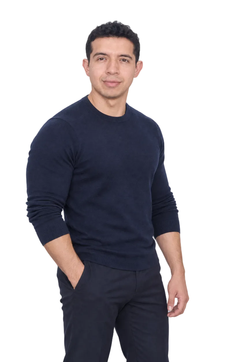 Alexander Ramírez, standing, in a navy crew-neck sweater